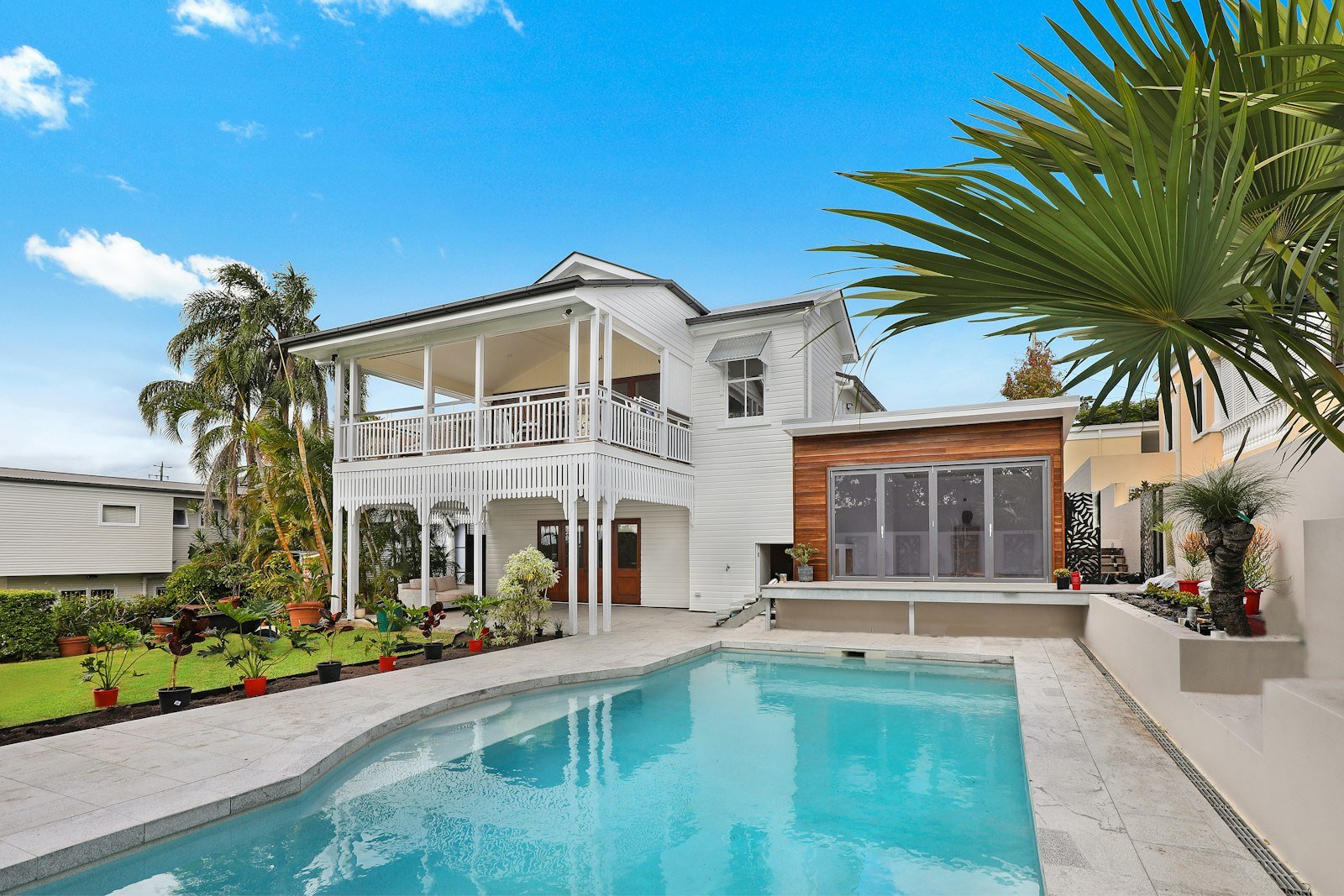 A modern home at twilight with warm lights on, representing a new home ready for its owners